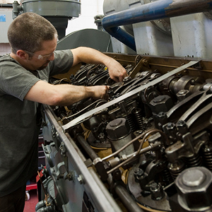 Mechanic repairing engine cylinder head